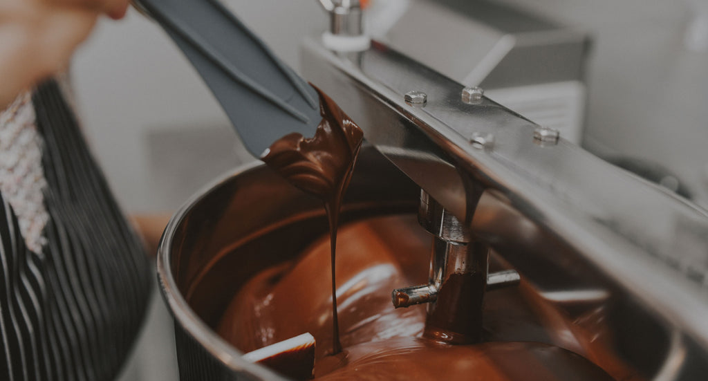 Dark chocolate being prepared in a commercial kitchen.